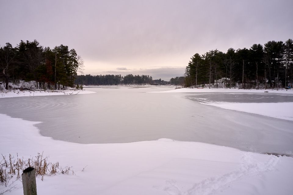 The lake, still, with hills behind